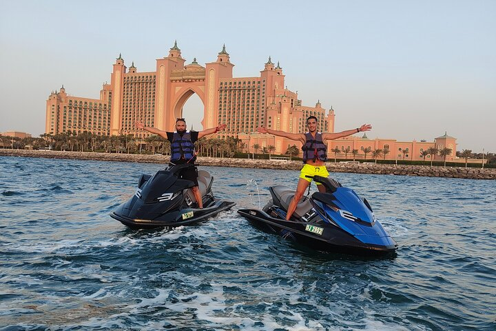 Experience the serene beauty of Jumeirah Beach while jet skiing amidst stunning views of the iconic architecture creating lasting memories and perfect photos in Dubai's spectacular setting.